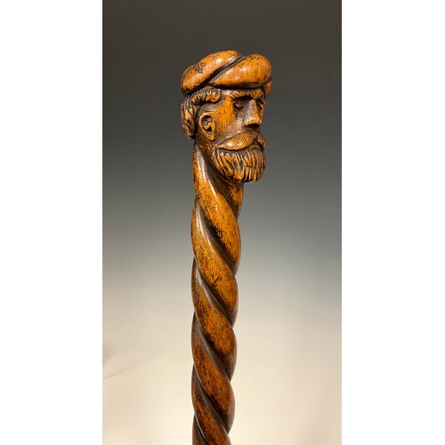 710 - A 19th century folk art walking stick / walking cane, the pommel carved as the head of a bearded man... 