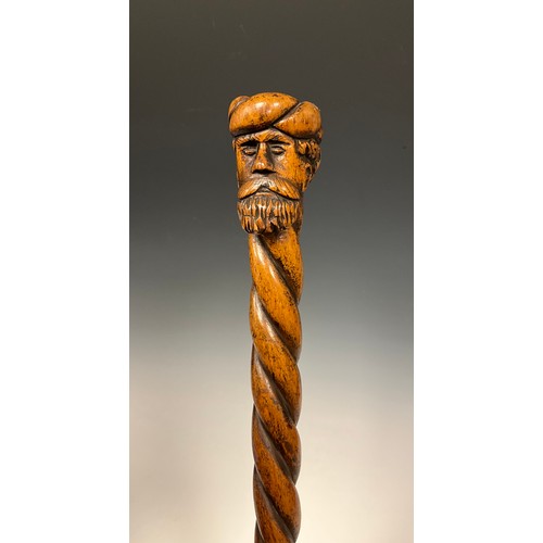 710 - A 19th century folk art walking stick / walking cane, the pommel carved as the head of a bearded man... 