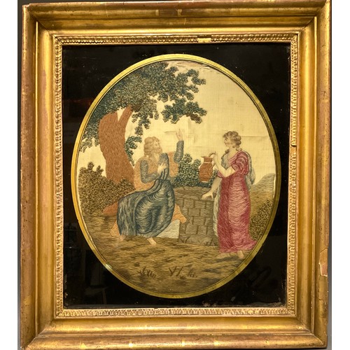 1130 - A Georgian needlework panel, Rebecca at the Well, black and gilt oval glass mount, 37cm  31.5cm, fra... 