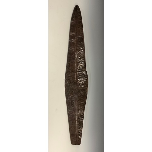 903 - A 19th century Aborigine carved parrying shield, of flat bottomed elliptical form, the facia carved ... 