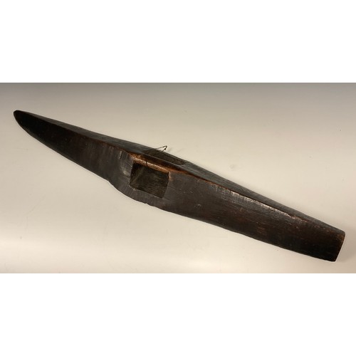 903 - A 19th century Aborigine carved parrying shield, of flat bottomed elliptical form, the facia carved ... 