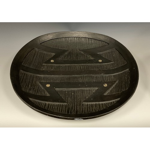 322 - Jason Wason (b.1946) a studio pottery dished ovoid bowl, relief moulded with tribal motifs, 39.5cm w... 