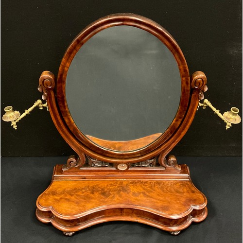 1036 - A Victorian flame mahogany dressing table mirror, the oval mirror on a pierced and carved cradle sup... 