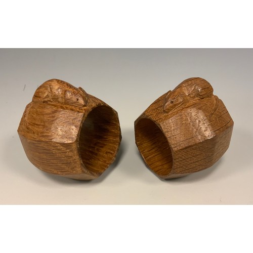 1144 - A pair of Robert Thompson of Kilburn Mouseman napkin rings, of octagonal form, each with carved mous... 