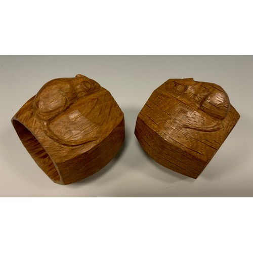 1144 - A pair of Robert Thompson of Kilburn Mouseman napkin rings, of octagonal form, each with carved mous... 