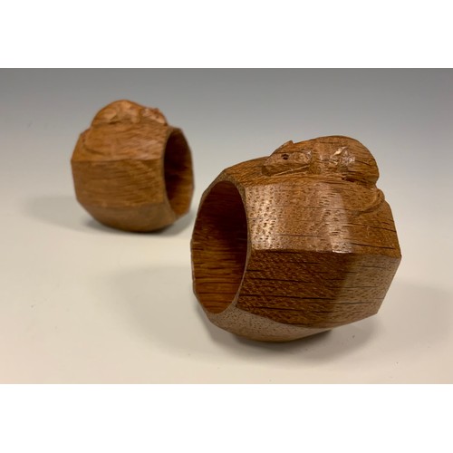 1144 - A pair of Robert Thompson of Kilburn Mouseman napkin rings, of octagonal form, each with carved mous... 