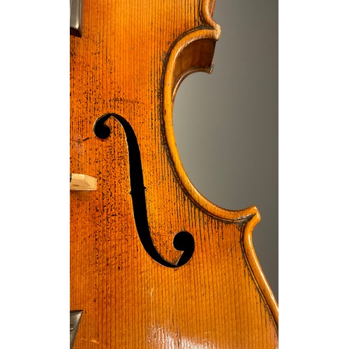 1074 - A late 19th / early 20th century violin, after Antonio Stradivari, having a well-figured two-piece b... 