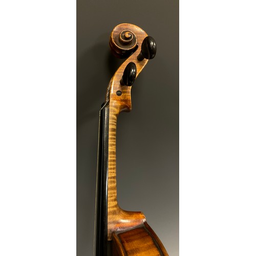 1074 - A late 19th / early 20th century violin, after Antonio Stradivari, having a well-figured two-piece b... 