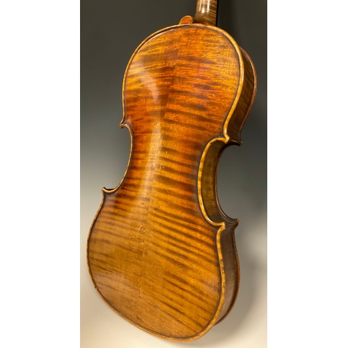 1074 - A late 19th / early 20th century violin, after Antonio Stradivari, having a well-figured two-piece b... 