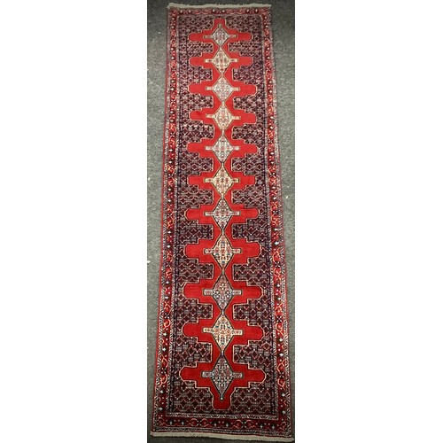 1096 - A North-west Persian Senneh ruuner carpet, hand-knotted, 405cm x 93cm.