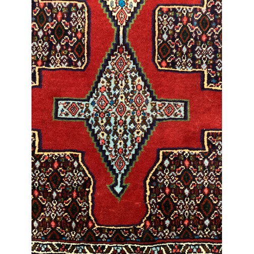 1096 - A North-west Persian Senneh ruuner carpet, hand-knotted, 405cm x 93cm.