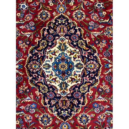 1090 - A Central Persian Kashan carpet, hand-knotted in rich colours, red, deep and pale blue, and white, 3... 