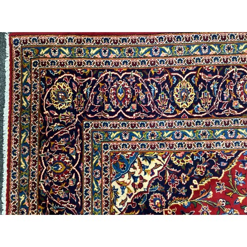 1090 - A Central Persian Kashan carpet, hand-knotted in rich colours, red, deep and pale blue, and white, 3... 