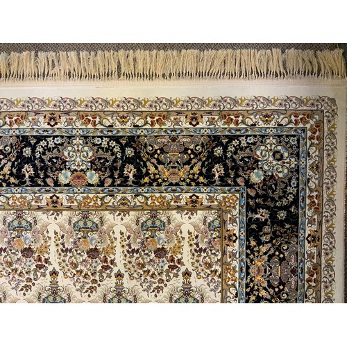 1087 - A silk and wool mix Keshan carpet, central field intricately decorated with bands of flowering urns,... 