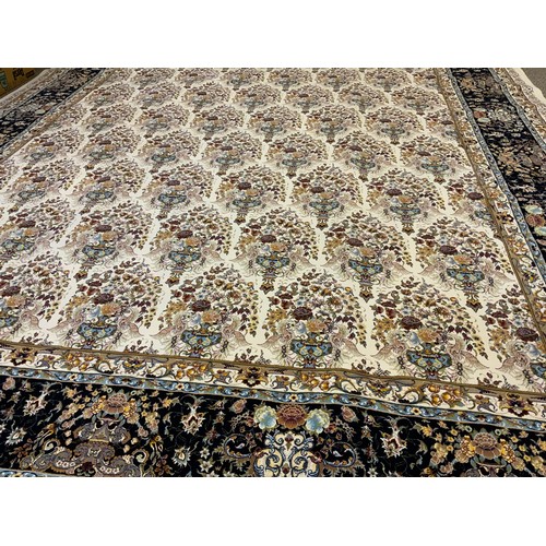 1087 - A silk and wool mix Keshan carpet, central field intricately decorated with bands of flowering urns,... 