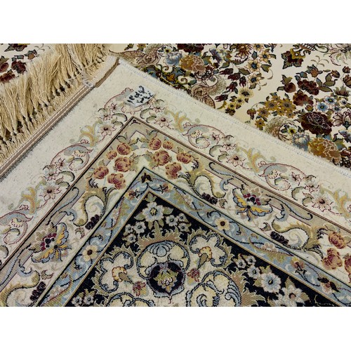 1087 - A silk and wool mix Keshan carpet, central field intricately decorated with bands of flowering urns,... 