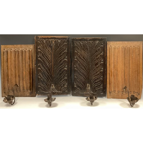 1234 - A pair of carved oak linen fold panel back wall lights, with single arm iron candle holders,37cm x 2... 