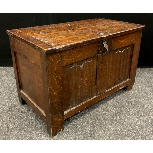 1282 - An early 17th century oak blanket chest or coffer of small proportions, two linen-fold carved panels... 