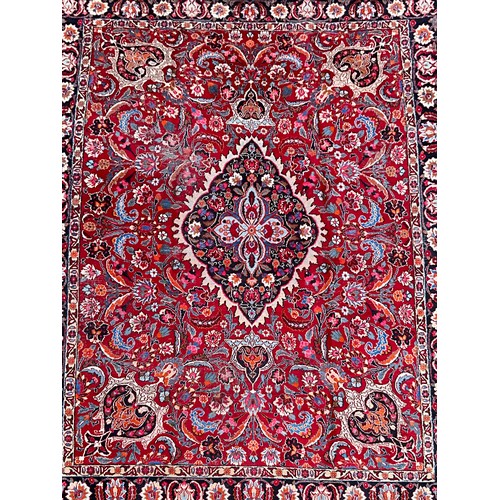 1285 - A Persian Kirman carpet, all over floral garden design inc tones of blue, cream, pink and black, on ... 