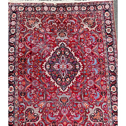 1285 - A Persian Kirman carpet, all over floral garden design inc tones of blue, cream, pink and black, on ... 