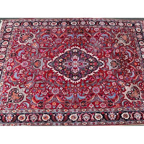 1285 - A Persian Kirman carpet, all over floral garden design inc tones of blue, cream, pink and black, on ... 