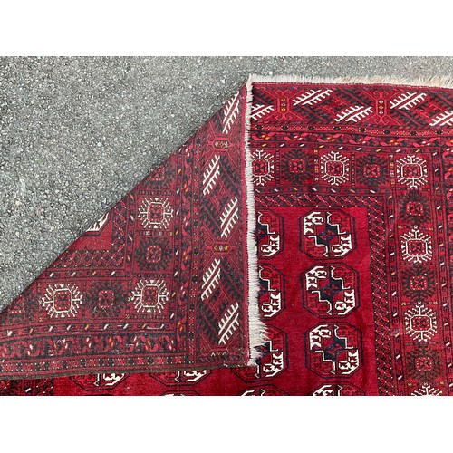 1286 - A Tekke Torkman hand-knotted rug, with four bands of geometric guls, in white, black and blue on red... 