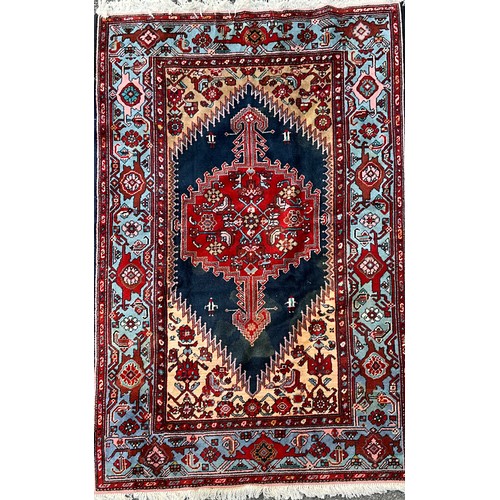 1287 - A Hamedan rug, central shaped red lozenge within blue field, all surrounded by floral ground and bor... 