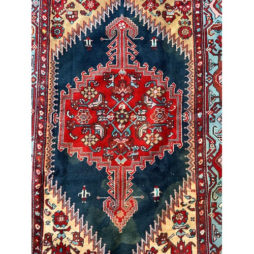 1287 - A Hamedan rug, central shaped red lozenge within blue field, all surrounded by floral ground and bor... 