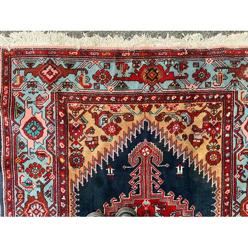 1287 - A Hamedan rug, central shaped red lozenge within blue field, all surrounded by floral ground and bor... 