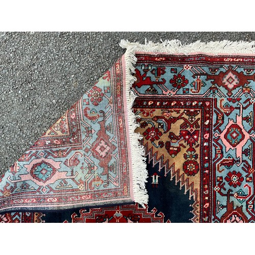 1287 - A Hamedan rug, central shaped red lozenge within blue field, all surrounded by floral ground and bor... 