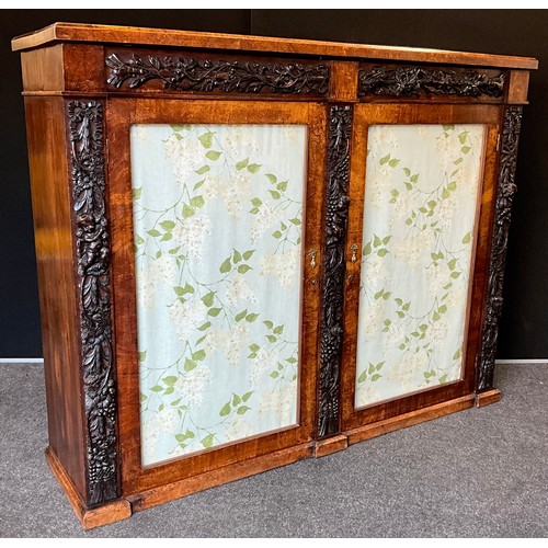 1063 - A Regency oak and walnut carved side cabinet, from Churchdale Hall, Ashford in the Water, walnut top... 