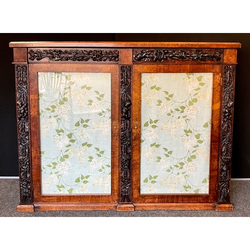 1063 - A Regency oak and walnut carved side cabinet, from Churchdale Hall, Ashford in the Water, walnut top... 