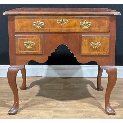 102 - A George II Revival walnut lowboy, of three drawers, 73.5cm high, 78.5cm wide, 46.5cm deep