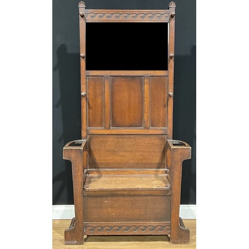 117 - A 17th century style oak entrance hall box settle, rectangular back with bevelled mirror plate flank... 