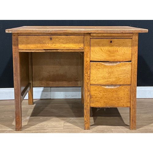 119 - A mid-20th century oak desk, rectangular top above a slide and an arrangement of four drawers, 75.5c... 