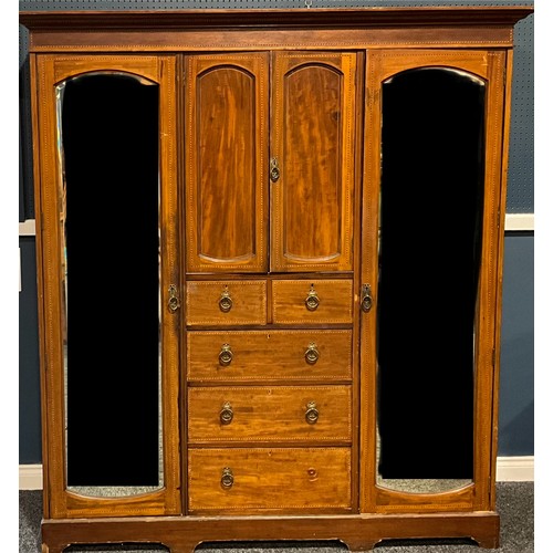 120 - An Edwardian mahogany compactrum wardrobe, centred by a pair of panel doors, two short and three lon... 