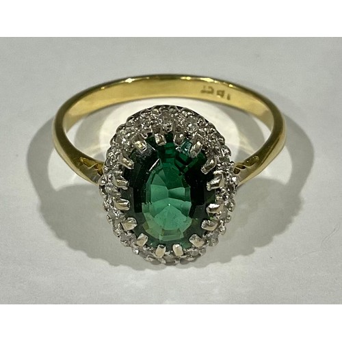 411 - An 18ct gold emerald and diamond ring, size O, 3.7g