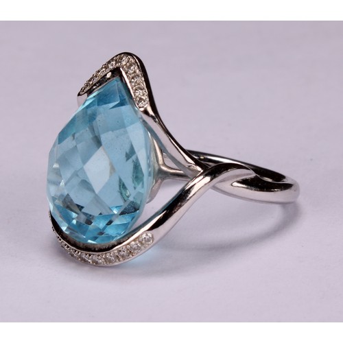 420 - An impressive topaz and 18ct white gold ring, the large sky blue pear shape facet cut stone set with... 