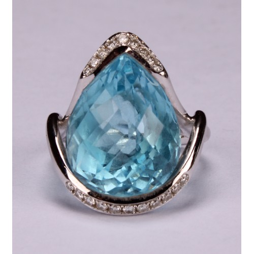 420 - An impressive topaz and 18ct white gold ring, the large sky blue pear shape facet cut stone set with... 