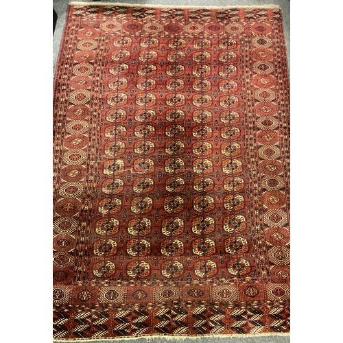 1289 - A Turkman Bokhara rug, hand-knotted, typical repeating geometric design, in red with black, orange, ... 