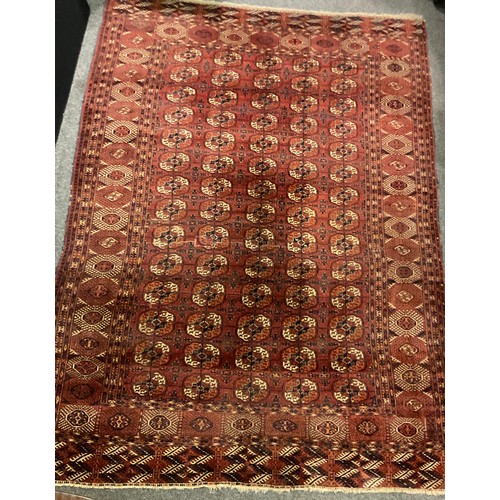 1289 - A Turkman Bokhara rug, hand-knotted, typical repeating geometric design, in red with black, orange, ... 