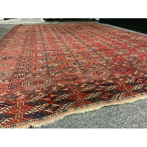 1289 - A Turkman Bokhara rug, hand-knotted, typical repeating geometric design, in red with black, orange, ... 