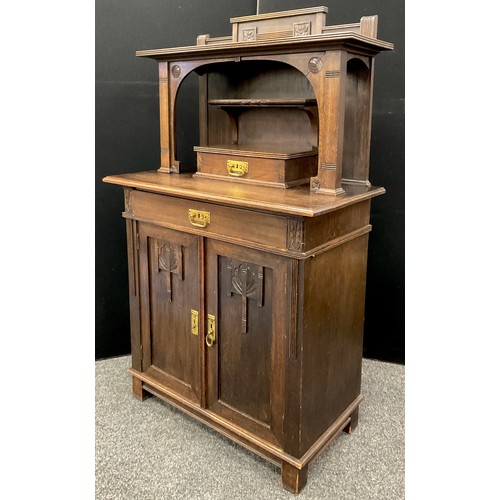 1290 - An Arts & Crafts oak dresser, the shaped upper section with single drawer, above a single long friez... 