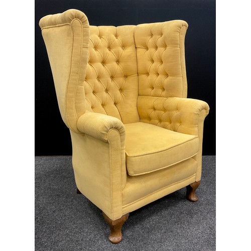 1296 - A Queen Anne revival deep wing-back armchair, with button-back and sides, cabriole legs, 105cm high ... 