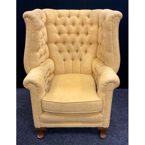 1296 - A Queen Anne revival deep wing-back armchair, with button-back and sides, cabriole legs, 105cm high ... 