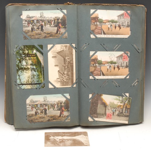 4059 - Postcards – an Edwardian postcard album, tall 4to embossed colour printed boards, (stained, spine re... 