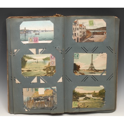 4059 - Postcards – an Edwardian postcard album, tall 4to embossed colour printed boards, (stained, spine re... 