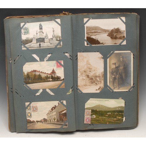 4059 - Postcards – an Edwardian postcard album, tall 4to embossed colour printed boards, (stained, spine re... 