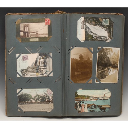 4059 - Postcards – an Edwardian postcard album, tall 4to embossed colour printed boards, (stained, spine re... 