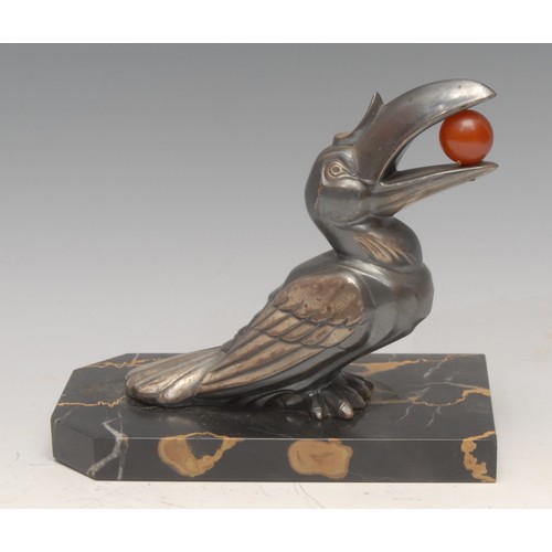 3642 - An Art Deco spelter desk weight, Toucan with polished spherical amber 